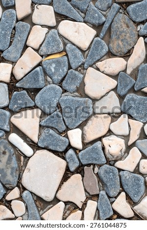 Seamless texture of flat smooth river stones and pebbles mosaic pavement background