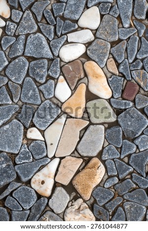 Seamless texture of flat smooth river stones and pebbles mosaic pavement background