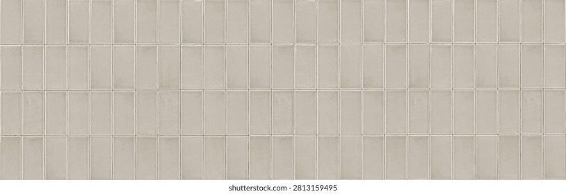 A seamless texture of vertical ceramic finger tiles in a warm beige color. The glossy glazed mosaic cladding features a clean stacked bond layout with thin light grout lines.