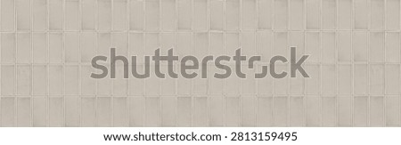 A seamless texture of vertical ceramic finger tiles in a warm beige color. The glossy glazed mosaic cladding features a clean stacked bond layout with thin light grout lines.