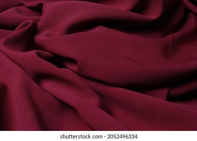 Seamless wavy maroon chiffon texture with fabric details. Luxurious chiffon textile pattern in soft and silky material.