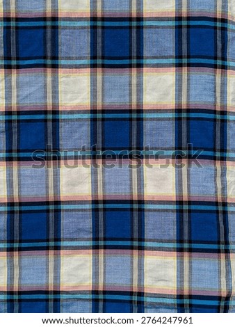 Seamless-looking blue flannel plaid pattern, box-shaped sarong design dominated by blue in the middle and white on the edges, Traditional gingham or tartan fabric background for apparel design