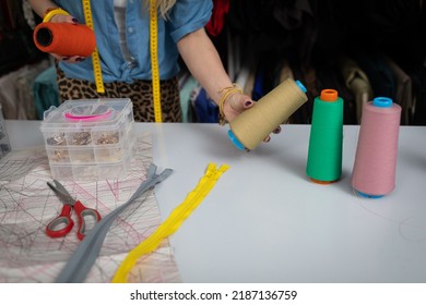 The seamstress selects the answer color of thread for the next dress. - Shutterstock ID 2187136759