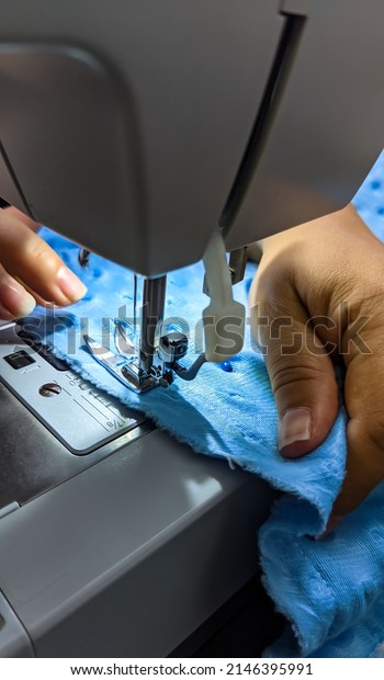 Seamstress sews clothes made  fabric on a sewing\
machine. Work in the light of the built-in hardware lamp. Steel pin\
with looper and presser foot\
closure.