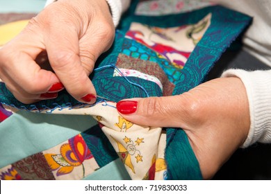 Seamstress Woman Sewing For Finish A Quilt.