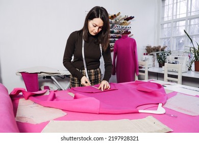 Seamstress working with sewing pattern on table in tailor shop - Shutterstock ID 2197928321