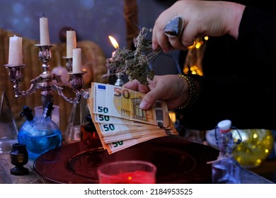 seance in salon of soothsayer, Librate with money, female hands of psychic doing witchcraft passes with euro banknotes, esoteric Oracle performs ritual of removing spell black magic, esoteric business - Shutterstock ID 2184953525