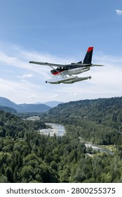 Seaplane floatplane flying over a river valley and dense forest with mountain views, evoking adventure and freedom — 3d Rendering, Background in BC, Canada.