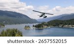 A seaplane soars over a tranquil forest-surrounded lake with distant mountains.