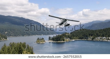 A seaplane soars over a tranquil forest-surrounded lake with distant mountains.
