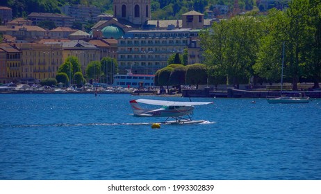 Seaplane. Ultralight Aviation In Europe. Lake. Hobbies And Sports. Tourism. Paroplane. Hydroplane. Airplane In The Air And On The Water. ITALY, Como, June 2021 