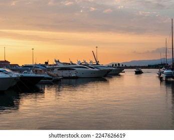 seaport, harbor, jetty at sunset. Calm sea and cloudy sky