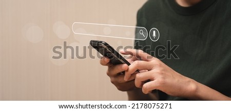 Search Engine Concept. Tools or programs for searching for information on the Internet. Man's hand using mobile phone to search for information using Search Engine and help your online business grow.