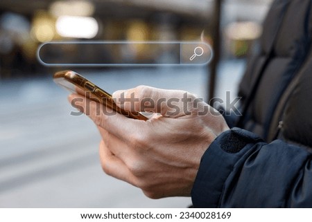 Search Engine Optimisation or SEO concept , Businessman holding smartphone for using input keyword and seraching and find information.