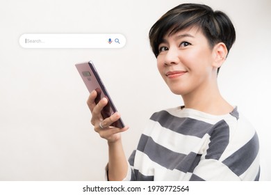 Search Engine Optimization - SEO concept. Portrait of a beautiful middle-aged asian woman using a smartphone and smile with satisfy. Machine learning, AI Artificial intelligence, Keyword, Lifestyle. - Powered by Shutterstock