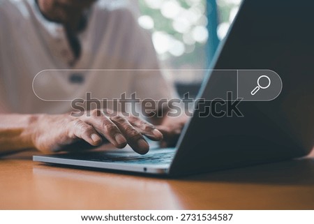 Search Engine Optimization SEO Networking Concept, Searching Browsing Internet Data Information with blank search bar. Senior man hand using computer laptop searching information online.