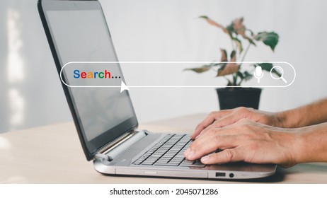SEARCH ENGINE OPTIMIZATION (SEO)SEO networking concept. With a blank search box, a searching browser of Internet data information is displayed. A businessman searches the internet on his laptop.