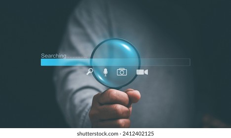 Search engine technology concept. Businessmen holding magnifying glass for searching information on internet network. Search progressing, Searching everything on internet network. voice, picture. - Powered by Shutterstock