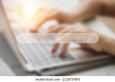 Search for information on web browser. Blurry background woman's hands typing on laptop.