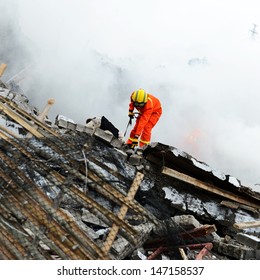 Search And Rescue Forces Search Through A Destroyed Building With The Help Of Rescue Dogs. 