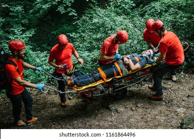 Search And Rescue Team Helping Injured Alpinist
