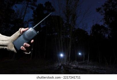 Search And Rescue Walkie Talkie With Two Flashlights In The Night Forest Behind