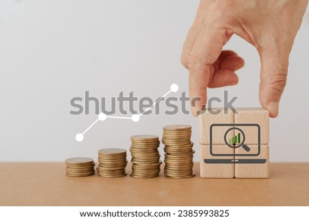 Search, Research, Finding Solution, Investigate Concept. Hand arranged wooden cube blocks with magnifying glass inside computer icon, and stack of coins. For marketing research. Customer insight. SEO