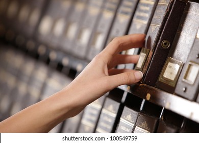 Searching In Archives. Student Hands Searching From A Filling Cabinet.