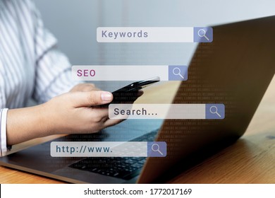 Searching and big online data concepts with businessmanwoman hand using laptop computer in office bar with search engine icon. seo, keywords and www.