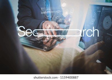 Searching Browsing Internet Data Information Networking Concept with blank search bar.Designer Businessman hand using smart phone,mobile payments online shopping with computer in modern office.