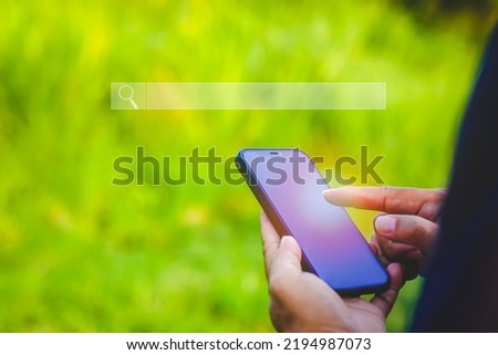 Searching Browsing Internet Data Information with blank search bar.SearchEngine Optimization SEO Networking Concept.handof businessman working with mobile phone outside the office