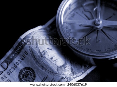 Searching for a financial direction. Compass and currency.