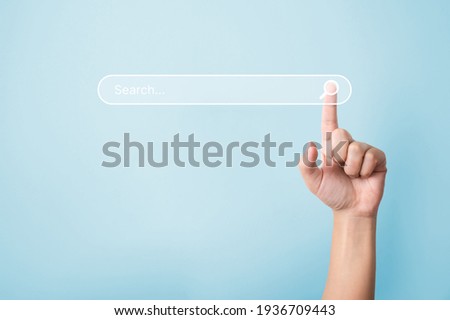 Searching information data on internet networking concept. Hand of man touching magnifying glass icon search