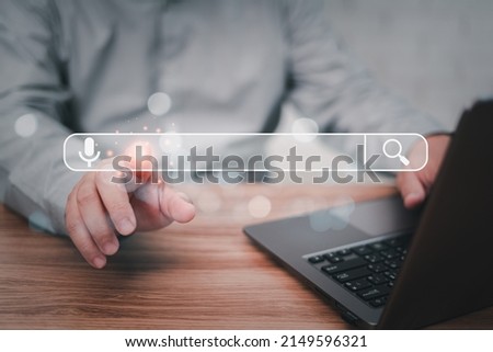 Searching information data on internet networking concept. Man point on Searching screen and use Laptop working on the table with texture and copy space