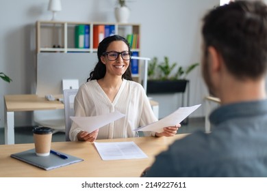 Searching for job concept. Happy human resources manager speaking to employment applicant on work interview, holding CV at office. Personnel manager talking to vacancy candidate - Shutterstock ID 2149227611