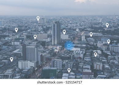 Searching location on map and pin above blue tone city scape and network connection, internet of things, satellite navigation system concept - Shutterstock ID 525154717