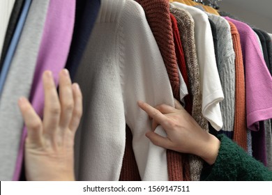 Searching And Shopping For Second Hand And Used Clothes In A Local Charity Shop