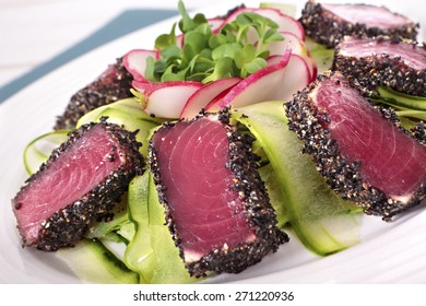 Seared Ahi Tuna Coated Sesame Seeds With Green Salad On White Plate. 