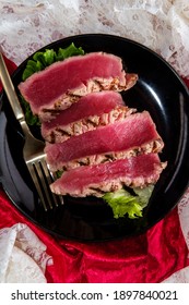 Seared Ahi Tuna With Grill Marks Sliced To Reveal Tender Pink Raw Inside