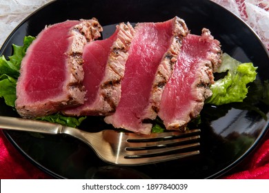 Seared Ahi Tuna With Grill Marks Sliced To Reveal Tender Pink Raw Inside