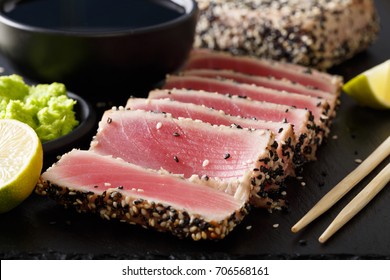 Seared Ahi Tuna With Sesame Seeds And Soy Sauce, Wasabi, Lime Macro On The Table. Horizontal
