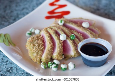 Seared Fresh Ahi Tuna Slices With Wasabi Peas And Sauce
