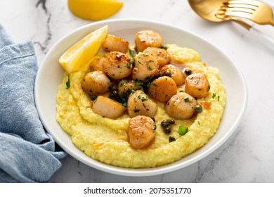 Seared scallops with grits and lemon butter sauce - Shutterstock ID 2075351770