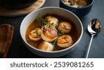 Seared Scallops ? Panned seared scallops in broth ready to eat.