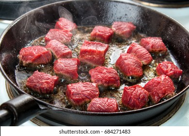 Searing Beef Bottom Round Roast Cubes In Cast Iron Skillet , Closeup