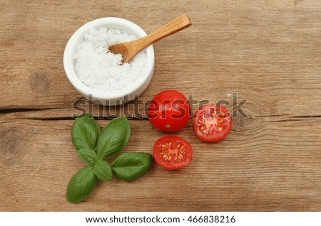 Seasalt tomatoes and basil on rustic wood