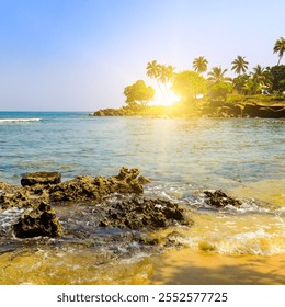 Seascape with beautiful waves, rocky shore, tropical palms and bright sunrise. Concept - vacation and travel. - Powered by Shutterstock