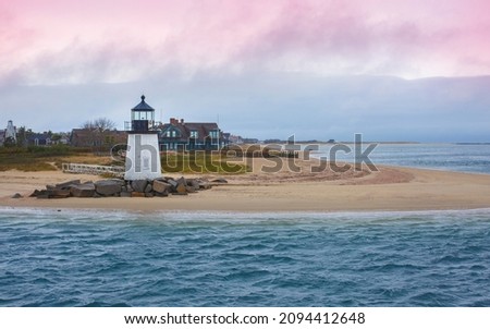 Seascape with Brant Point Lighthouse and dramatic pink clouds cape at twilight in Nantucket Massachusetts