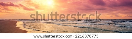 Seascape in the evening. Purple sunrise over sea. Horizontal banner