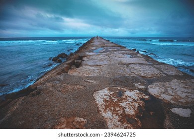 Seascape in the evening. Stone breakwater in the ocean - Powered by Shutterstock